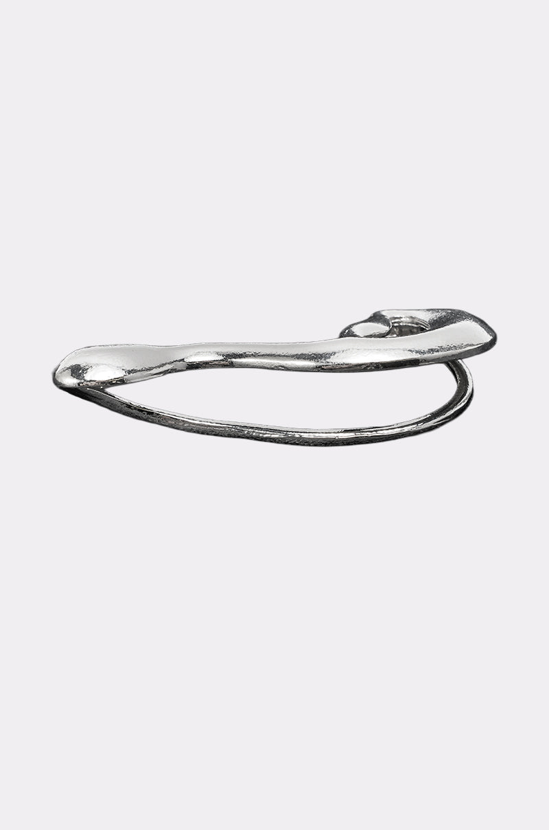 The STEF EAR CUFF features a unique, irregular, and slightly twisted silver design reminiscent of a modern safety pin, displayed against a plain light gray background. 3