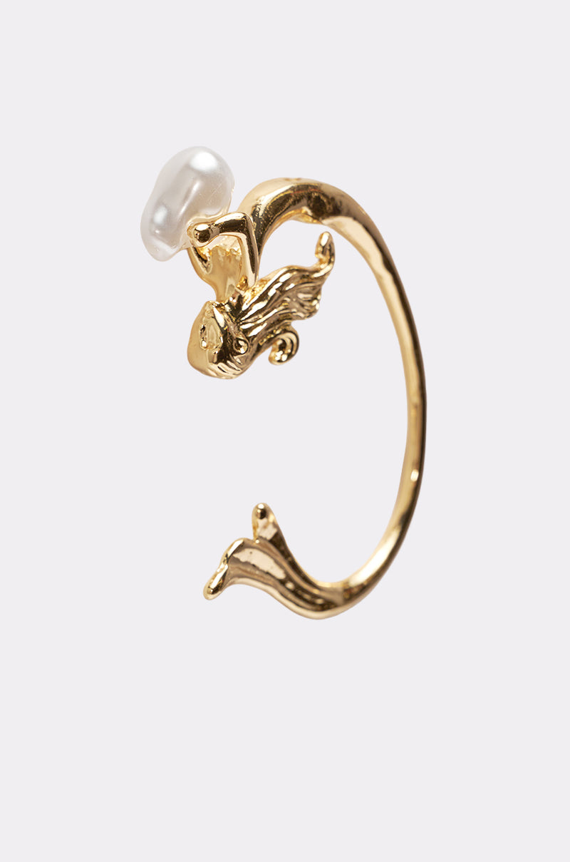 The SIREN EAR CUFF, shaped like a gold ring with detailed fins and flowing hair as the mermaid holds a pearl, is displayed on a plain white background. 2