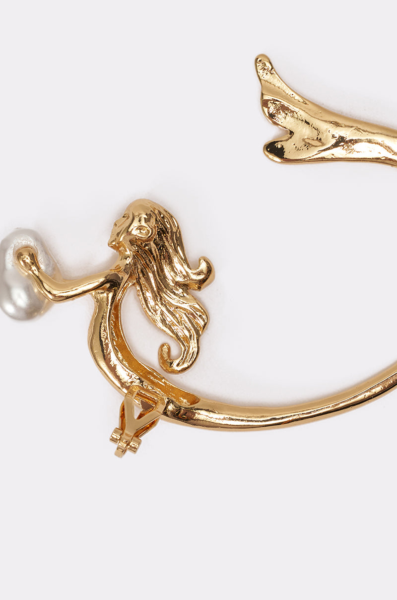 The SIREN EAR CUFF is a gold-tone ear cuff shaped like a mermaid with flowing hair, holding a faux pearl bead, shown against a plain white background. 4