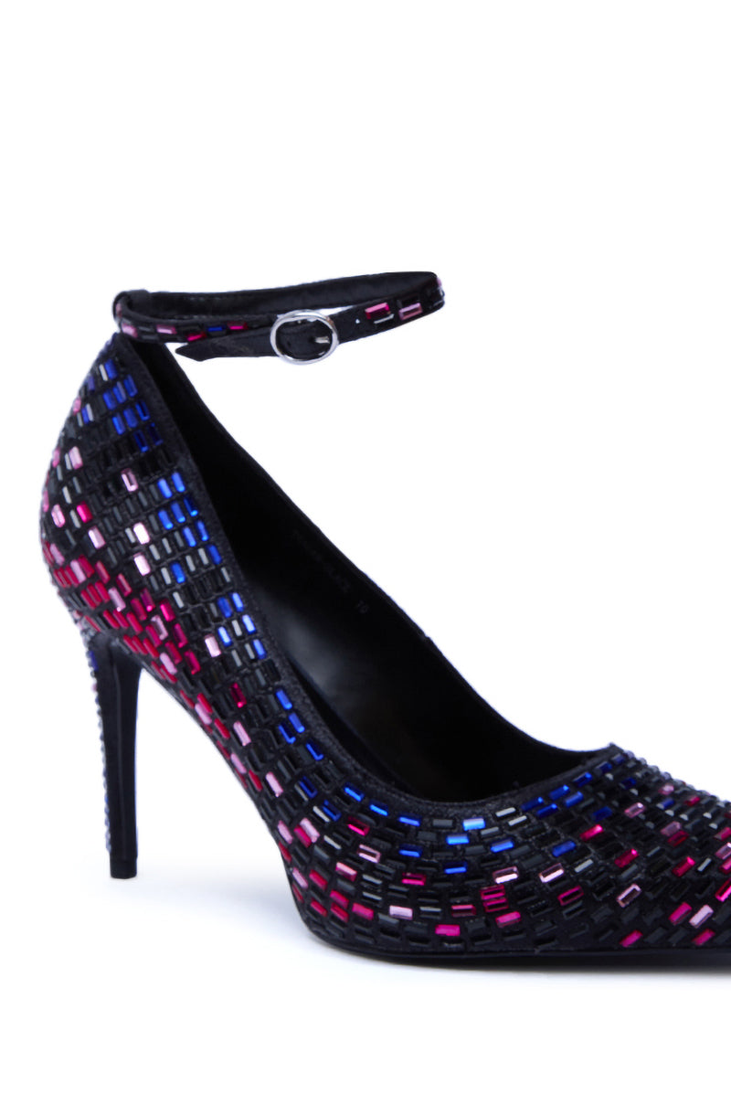 The AZALEA WANG TEAGAN BLACK MULTI RHINESTONE STRAP PUMP is a high-heeled stiletto with an ankle strap, featuring a black base adorned with small, colorful rhinestones in pink, blue, purple, and white patterns.