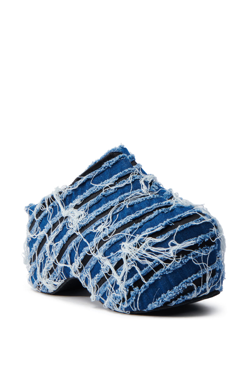 The AZALEA WANG TEATREE DENIM CLOG is a slip-on shoe with a distressed blue denim exterior, frayed design, and flatform sole, offering a unique textured and rugged style.