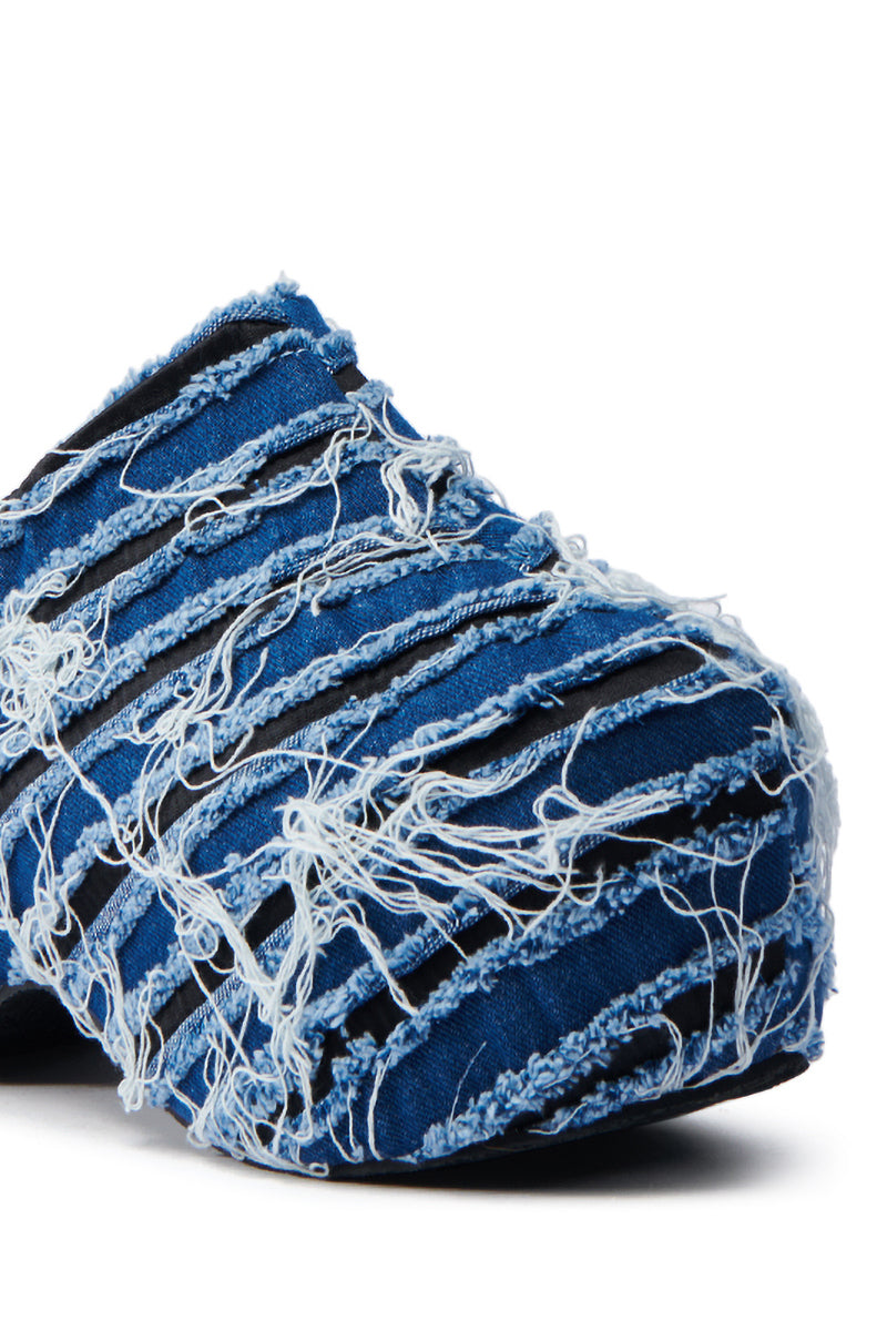 Close-up of the AZALEA WANG TEATREE DENIM CLOG showcasing a textured, distressed denim design with frayed and torn blue fabric. The clog features a chunky flatform sole, offering a rugged and unique style.