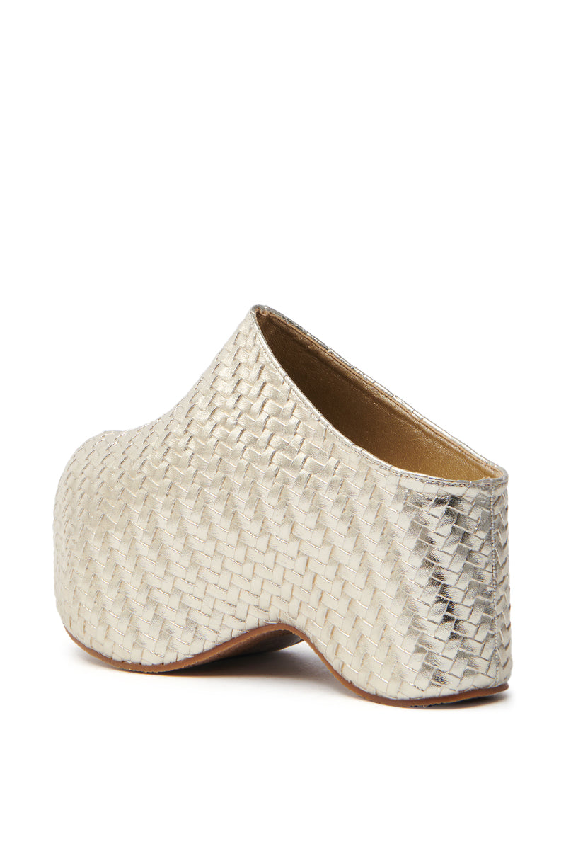 The AZALEA WANG TEATREE GOLD WOVEN CLOG is a single slip-on shoe featuring a closed toe, chunky heel, textured rattan-like pattern in metallic vegan leather, an open back, and a wooden sole.