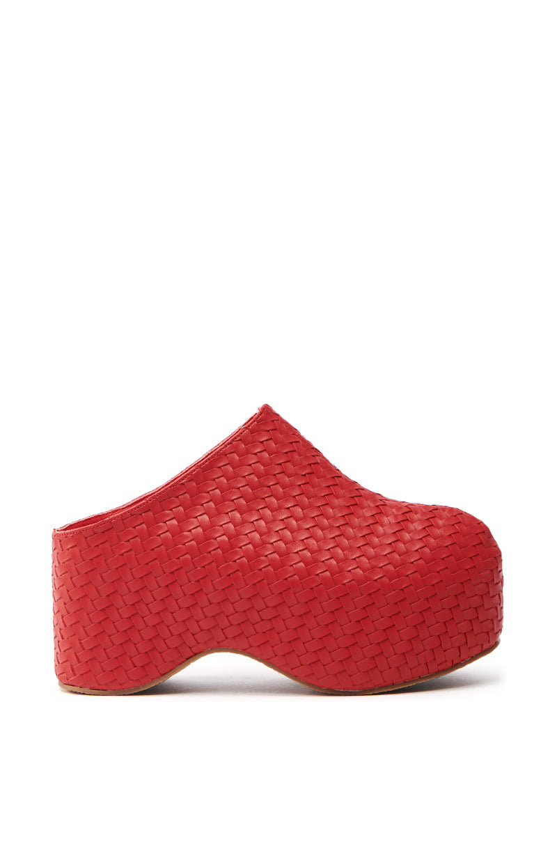 The AZALEA WANG TEATREE RED CLOG is a red woven slip-on with a high flatform sole, featuring an intricate basket-like texture, providing both style and comfort.