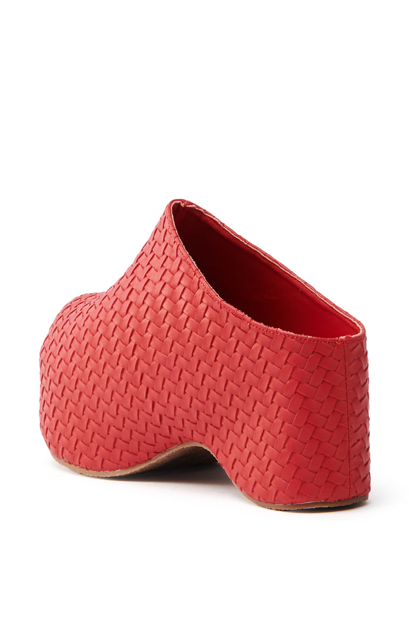 The AZALEA WANG TEATREE RED CLOG features a red woven design and a unique sculpted heel in vegan leather. Its basket-like texture enhances the look, while the flatform sole can be seen from the back.