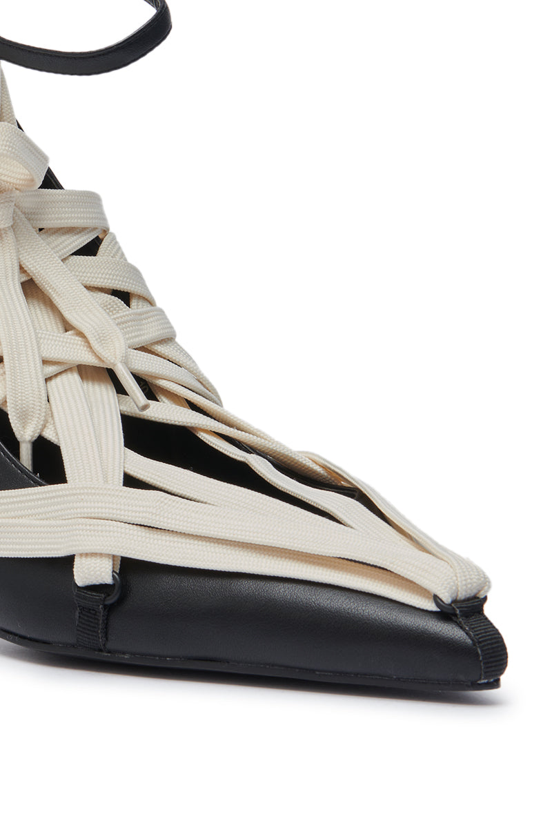 Close-up of the AZALEA WANG TELWONE LACES DETAIL PUMP, a black shoe featuring multiple off-white fabric straps that crisscross over the top and sides for an intricate woven, lace-up design.