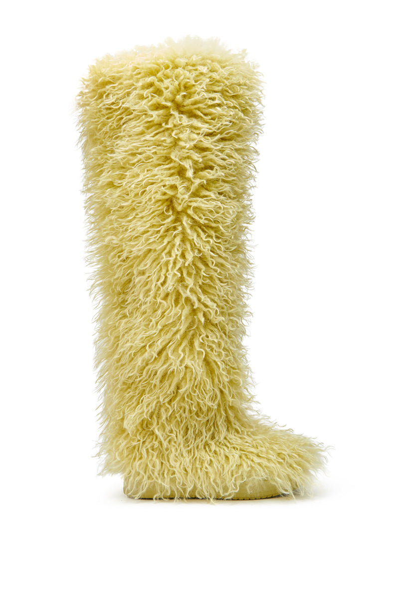 The AZALEA WANG TEMPLETON LIME POODLE FUR OVER THE KNEE BOOT features a thick, shaggy, lime faux fur upper for a textured look. Shown from the side against a plain white background.