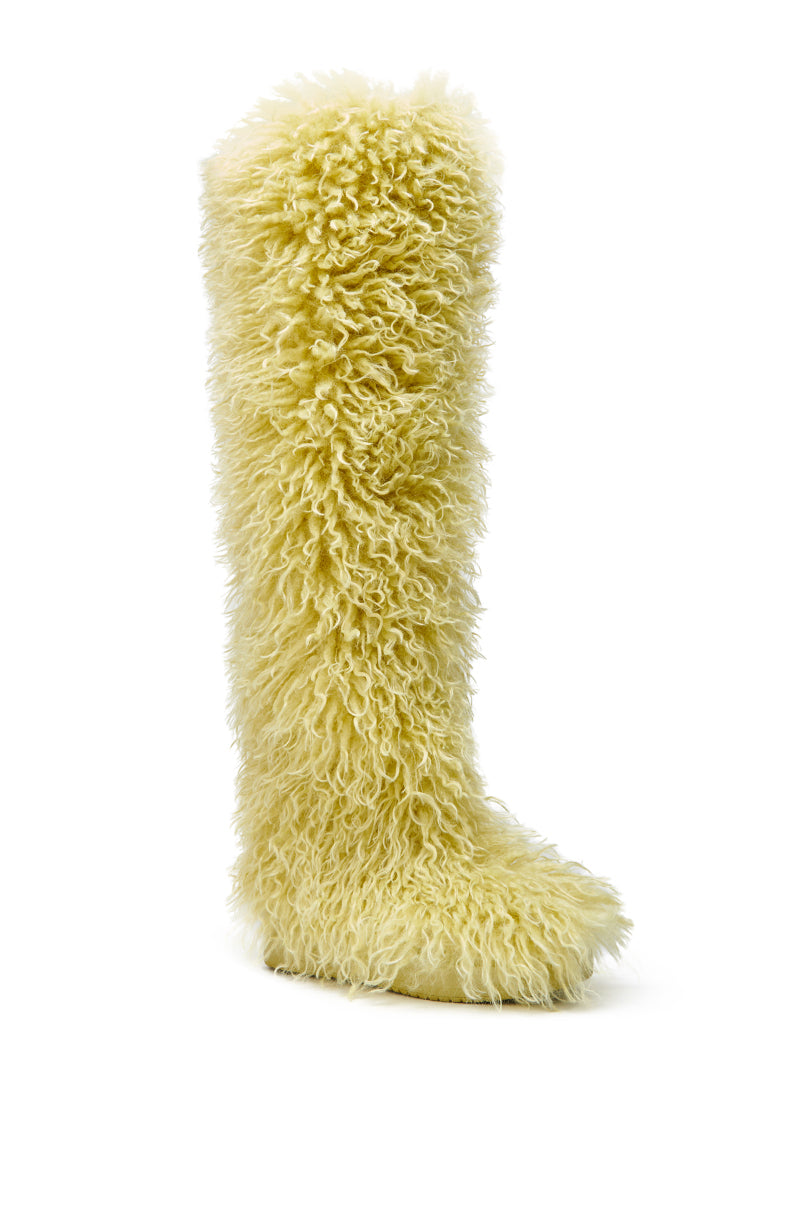 The AZALEA WANG TEMPLETON LIME POODLE FUR OVER THE KNEE BOOT stands upright against a white background, fully covered in fluffy lime faux fur for a playful, stylish twist on classic poodle fur boots.