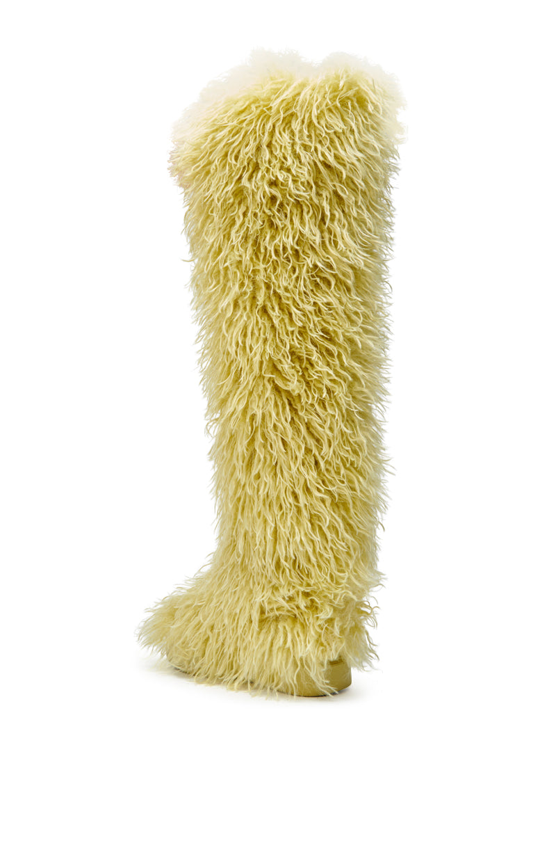 The AZALEA WANG TEMPLETON LIME POODLE FUR OVER THE KNEE BOOT, covered in shaggy, curly yellow faux fur, is displayed against a plain white background.