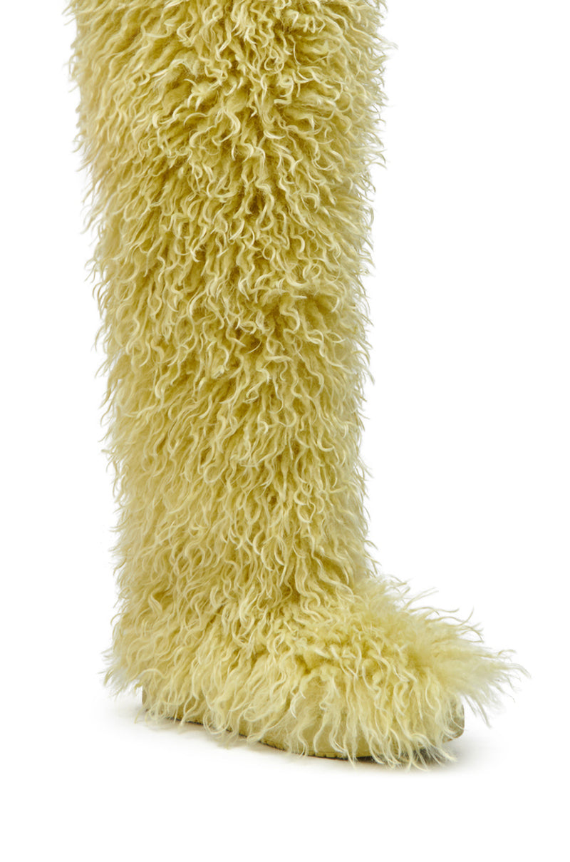 A close-up of the AZALEA WANG TEMPLETON LIME POODLE FUR OVER THE KNEE BOOT, a tall statement boot with long, shaggy lime faux poodle fur, shown against a plain white background.