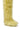 A close-up of AZALEA WANG TEMPLETON LIME POODLE FUR OVER THE KNEE BOOT, featuring shaggy yellowish faux fur resembling a fluffy animal’s leg, displayed against a white background.