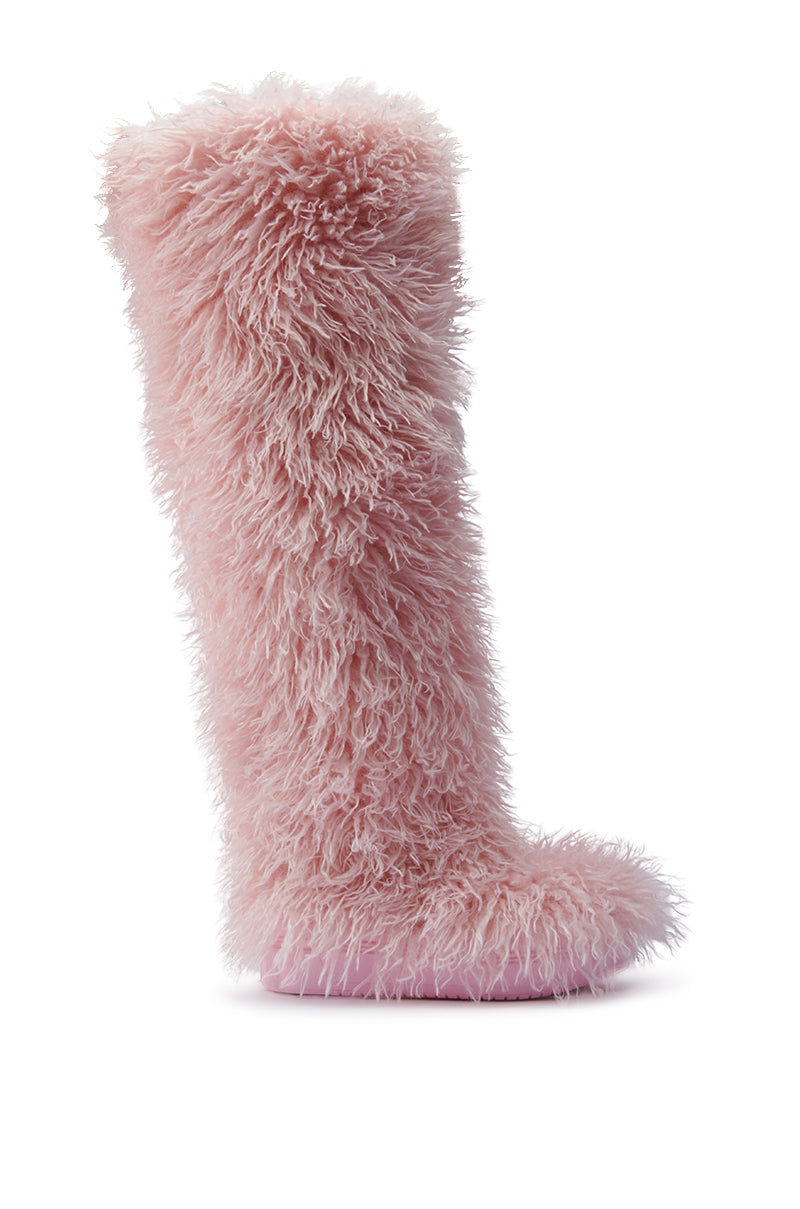 The AZALEA WANG TEMPLETON PINK POODLE FAUX FUR OVER THE KNEE BOOT features soft, fluffy pink fur and a smooth sole. This eye-catching knee-high boot is showcased against a pristine white background.