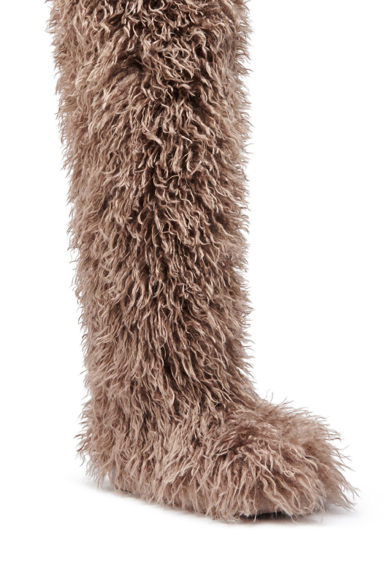 The AZALEA WANG TEMPLETON Taupe Poodle Fur Over The Knee Boot features shaggy, light brown faux fur and an elegant almond toe, styled to resemble an animal's leg and photographed against a white background.