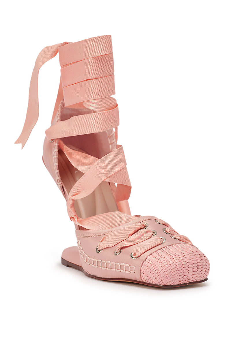 The AKIRA GOLD TENDU PINK BALLET LACE UP NOVELTY HEEL PUMP features a pale pink design with woven toe detail, lace-up front, wide ankle ribbons, comfort cushion insole, stitched edging, and closed toe for ballet-inspired elegance. 4