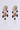 The DONATELLA EARRING showcases an elegant design with intricate floral motifs, embellished with multicolored gemstones, black beads, and teardrop pearl accents. This luxurious combination results in a stunning piece of gemstone jewelry characterized by sparkling details and an ornate appearance.