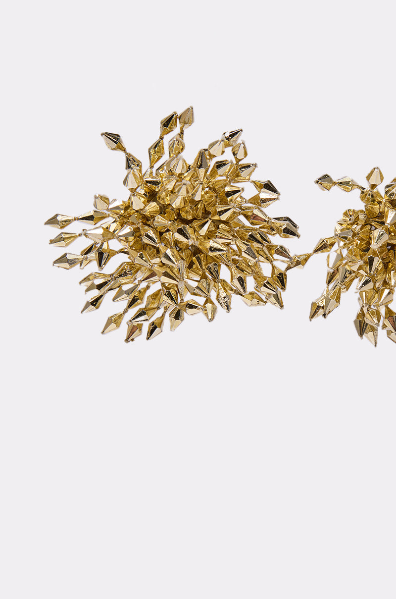 The EDGY VIBE EARRING features a gold sculptural design with intricate, spiky clusters for a bold look. Displayed on a white background, only part of the second earring is visible at the image’s right edge. 3