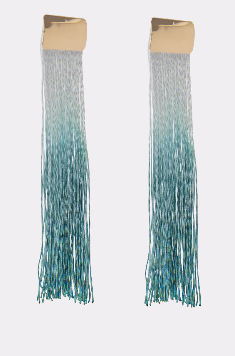 The REBRAND EARRING features long blue ombre tassel fringe with gold rectangular tops and teal strands flowing in thin threads—making them the perfect statement earrings for any outfit. 3
