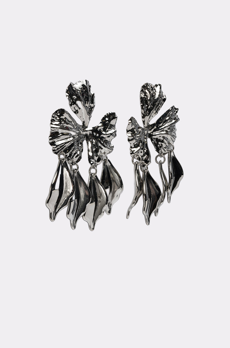 The IN BLOOM EARRING is a pair of silver-tone statement earrings with abstract butterfly shapes, textured wings, and dangling sculpted details. 5