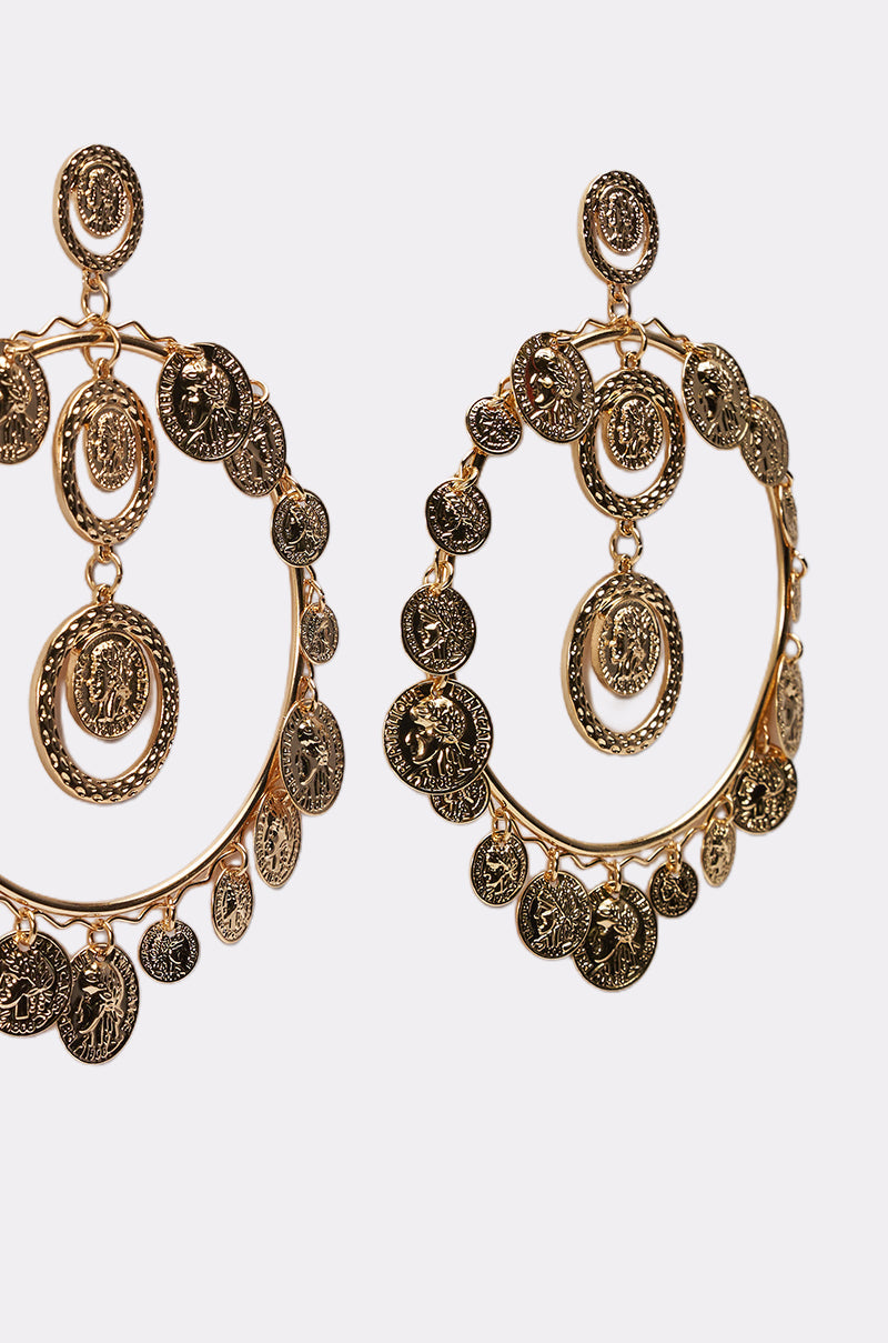 The BOHO EARRING features large antique gold hoops with intricate coin charms and filigree details, shown on a plain white background. 3