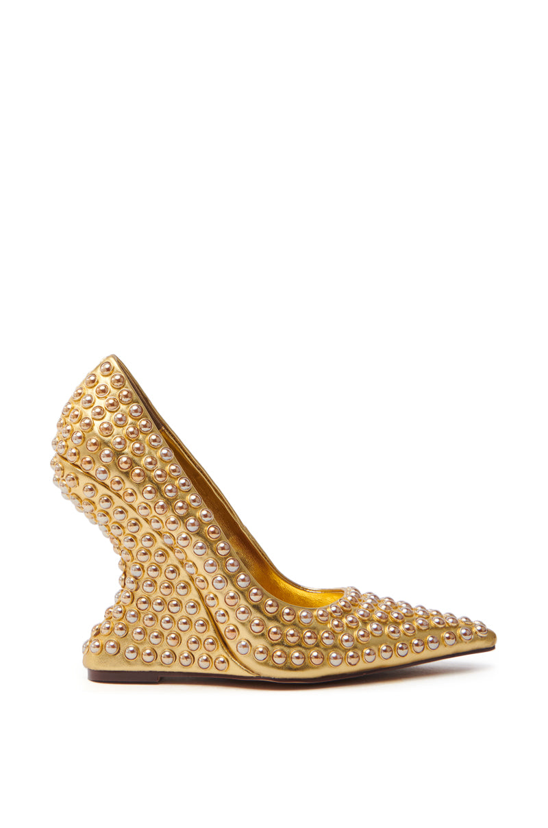 The AZALEA WANG TERYN GOLD WEDGE PUMP is a side view pointed toe high-heeled shoe, lavishly adorned with pearls. It's crafted from gold-toned metallic vegan leather and boasts a distinctive wedge heel design.
