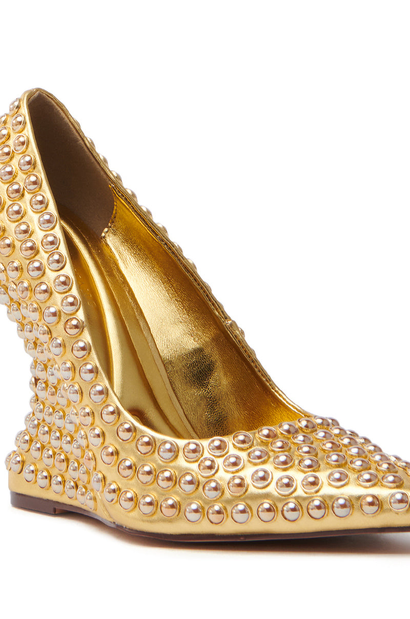 The AZALEA WANG TERYN GOLD WEDGE PUMP is a metallic vegan leather shoe featuring a pointed toe, shiny reflective finish, and elegant pearl studding.