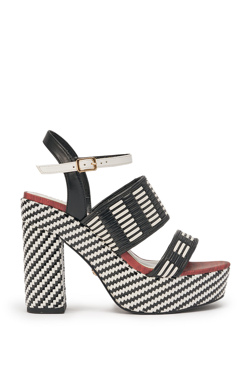 The AZALEA WANG TESERA BLACK WHITE PLATFORM WOVEN SANDAL features woven detailing, thick straps, an ankle buckle, a chunky block heel, an elevated sole, and a bold red accent near the footbed. 2