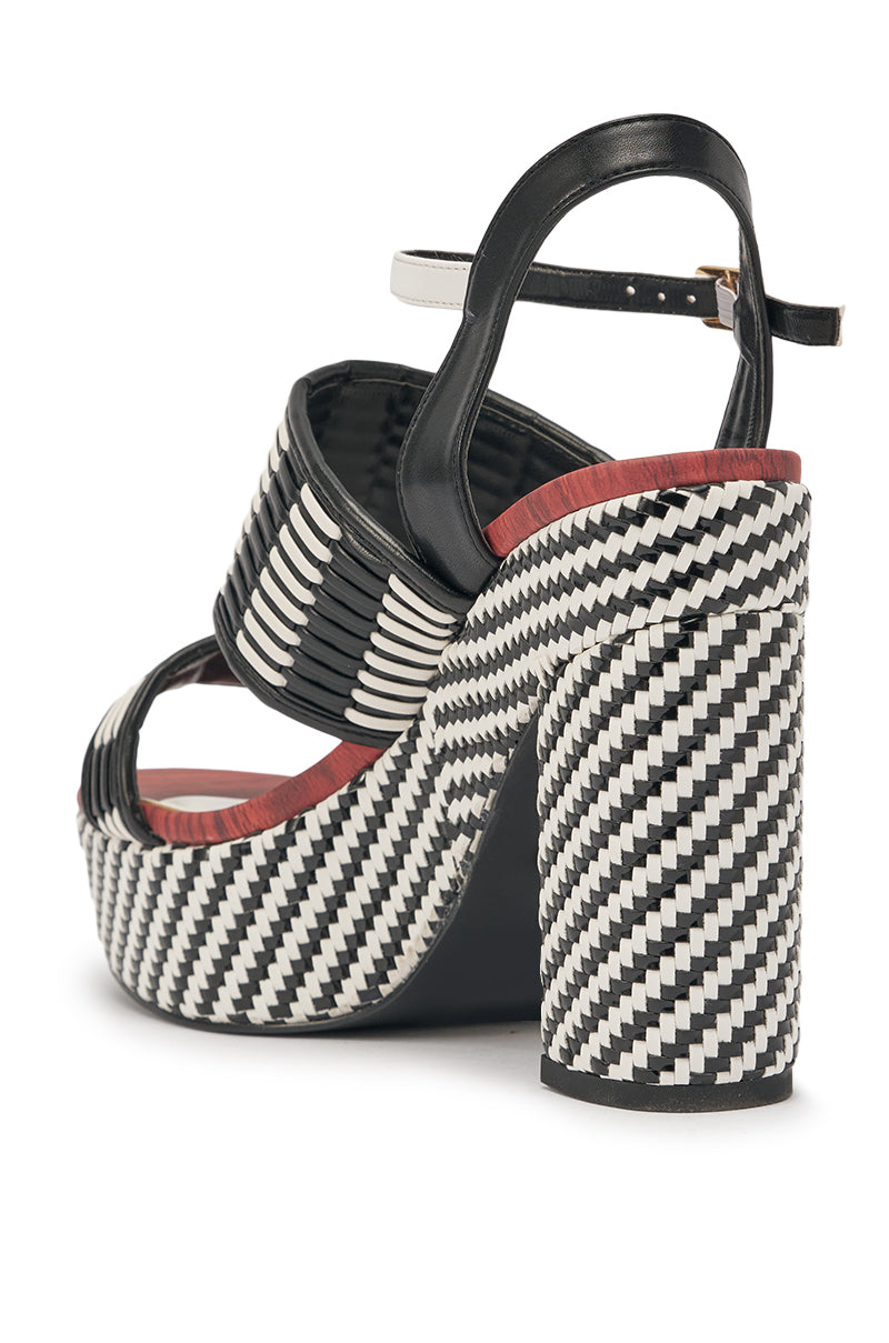 The AZALEA WANG TESERA BLACK WHITE PLATFORM WOVEN SANDAL features black and white woven straps, a gold buckle, chunky block heel, and a bold patterned sole—an eye-catching choice to elevate any look. 4