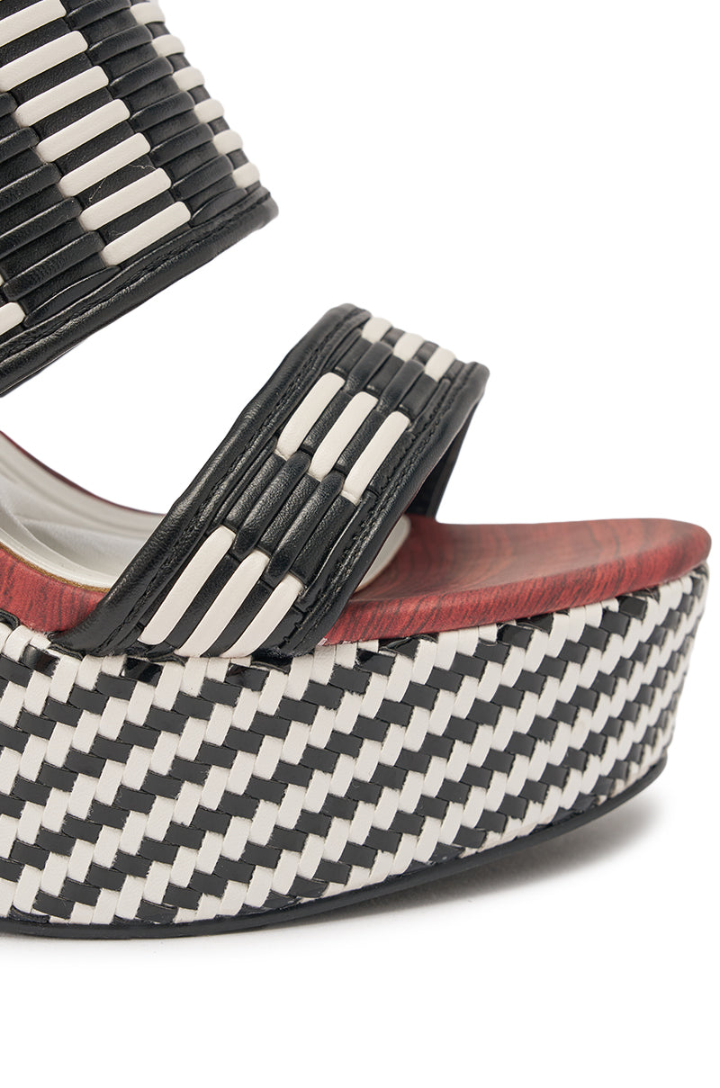 Close-up of the AZALEA WANG TESERA BLACK WHITE PLATFORM WOVEN SANDAL, featuring black and white woven straps and a matching chunky block heel with a wood accent near the footbed. 5
