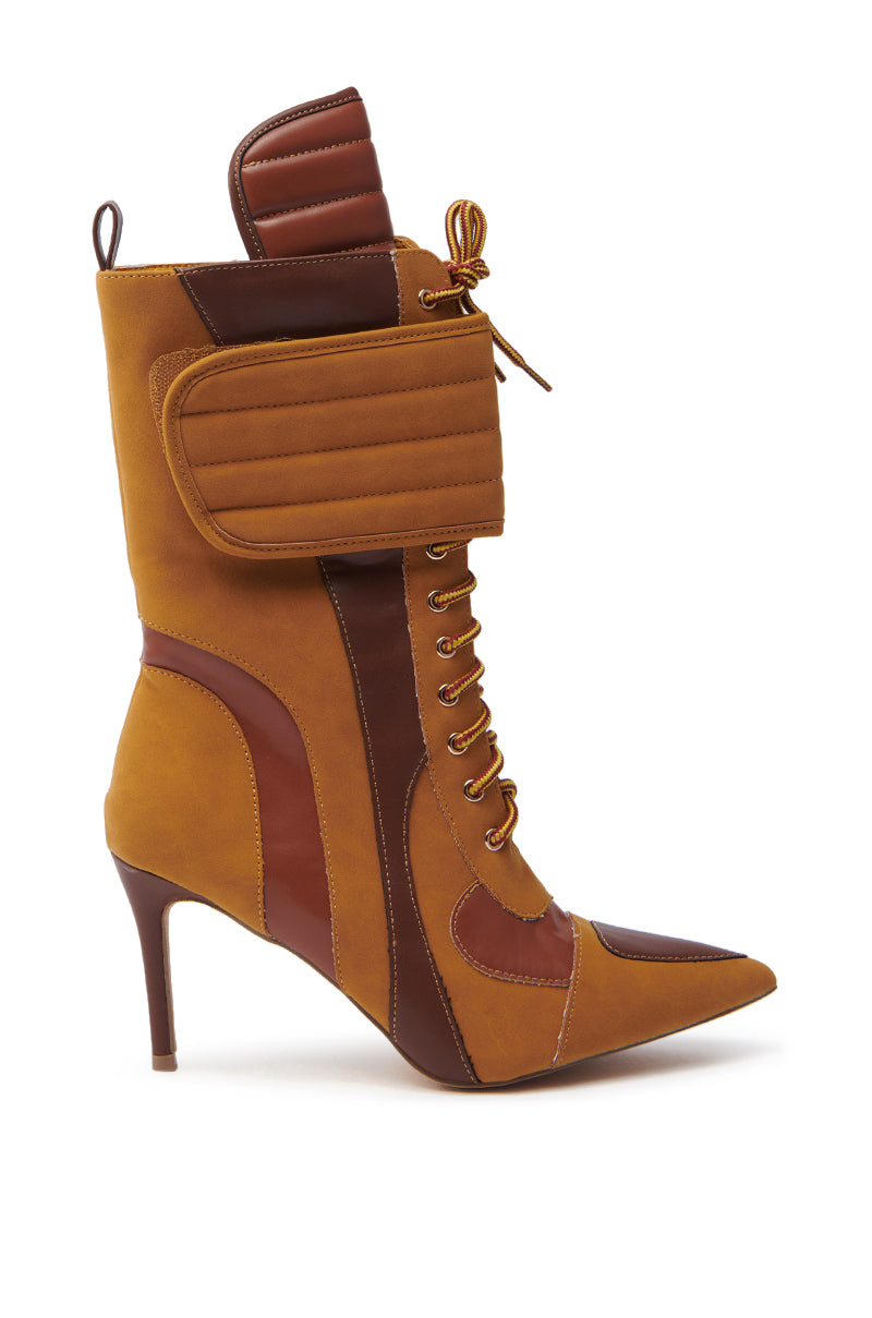 The TESS CAMEL STILETTO BOOTIE features a stylish pointed toe and lace-up design with a brown and tan faux suede upper, quilted details, and an ankle strap. Its stiletto heel and sleek silhouette give it a fashionable look. 3
