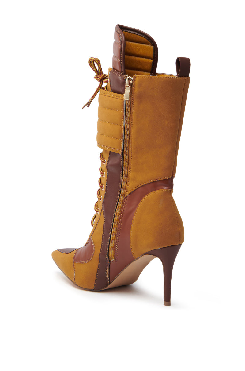 The TESS CAMEL STILETTO BOOTIE flaunts a side view with brown and tan faux suede upper leather sections, pointed toe, lace-up front, side zipper, padded top detail, and a sleek stiletto heel. 5