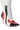 Introducing the TESS MULTI RACER BOOTIE: a fashionable women's high-heeled ankle boot with a pointed toe, showcasing a chic color block design in white, red, and black. This faux leather bootie features elegant white laces, a sleek stiletto heel, and quilted white padding around the ankle for added style and comfort.