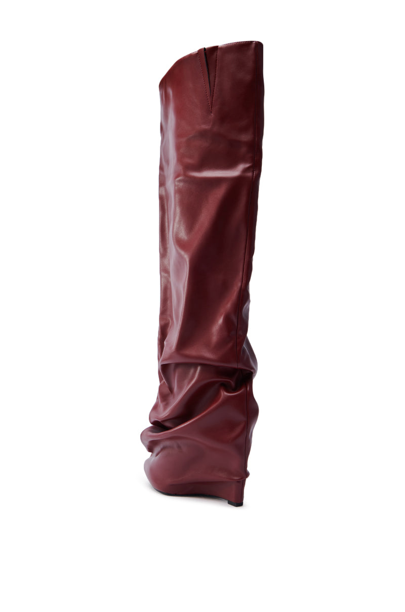The AZALEA WANG TEUILA BURGUNDY WEDGE RUCHED BOOT is a tall, slouchy thigh-high boot with a sleek design, subtle heel, and soft glossy finish, showcased from the side on a white background.