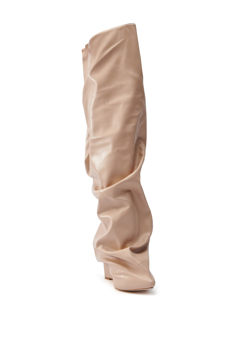 The AZALEA WANG TEUILA BONE WEDGE RUCHED BOOT is a single, beige, knee-high boot made from vegan leather with a slouchy design and slightly pointed toe, shown in side view on a white background.