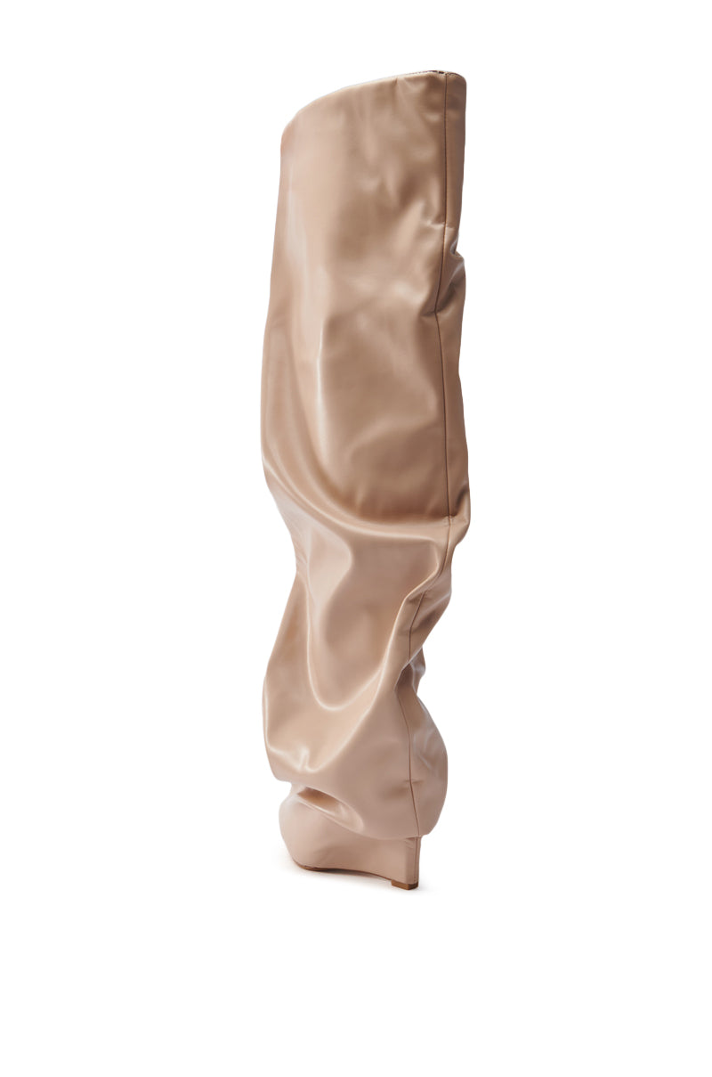 A single AZALEA WANG TEUILA BONE WEDGE RUCHED BOOT in beige vegan leather is displayed upright on a white background, showcasing its slouchy, oversized high-heel design with a smooth, slightly shiny texture.