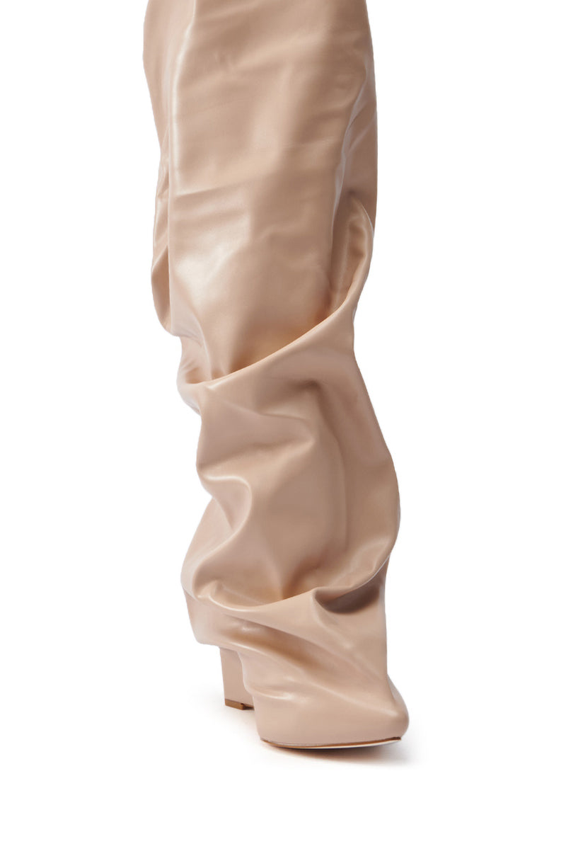 A close-up of the AZALEA WANG TEUILA BONE WEDGE RUCHED BOOT, featuring beige over-the-knee design with a square toe and block heel in glossy vegan leather. The slightly wrinkled material adds a stylish, relaxed look.