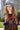 A young woman with long, wavy hair wears the IT GURL PU BRIM HAT in gray and a black mesh top with red sequined 