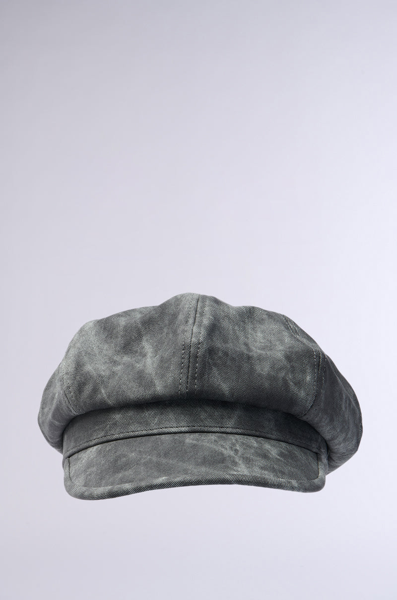 The IT GURL PU BRIM HAT is a gray, vintage-inspired baker boy cap with a faux leather PU brim, subtle AKIRA Label detailing, and a slightly worn texture. Displayed on a light gray background.