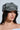 A woman with long dark hair wears the AKIRA Label IT GURL PU BRIM HAT in gray, large hoop earrings, and a strapless white top, looking slightly to the side against a light background.
