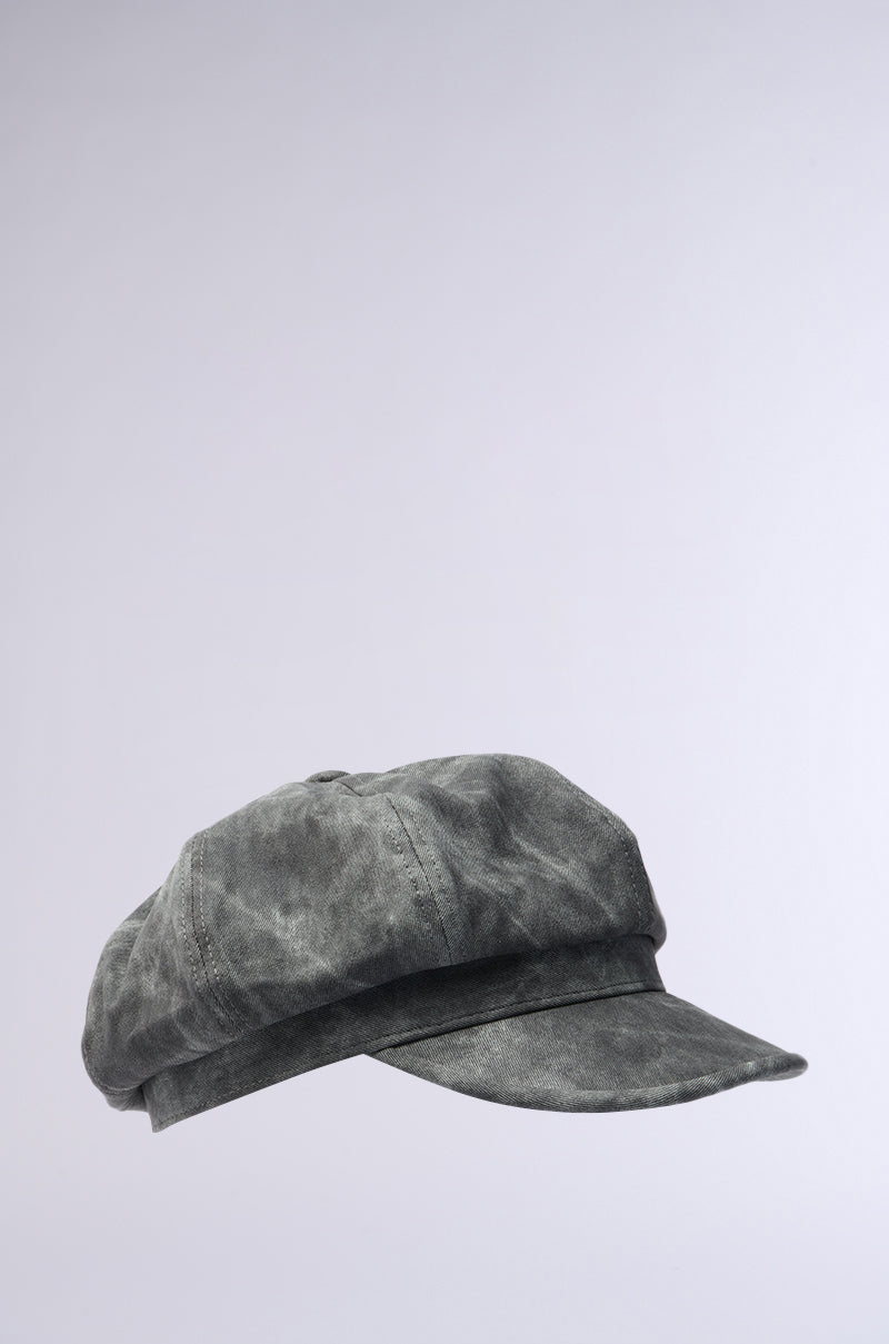 The IT GURL PU BRIM HAT, a gray newsboy cap with an AKIRA label, features a flat round crown and a short faux leather brim, displayed against a plain light gray background for a modern look. 5