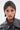 Wearing the ELI BLING HAIR TURBAN, a person in a black leather jacket looks straight at the camera. Their rhinestone-studded turban, neutral expression, and multiple nose piercings make for a bold festival look.