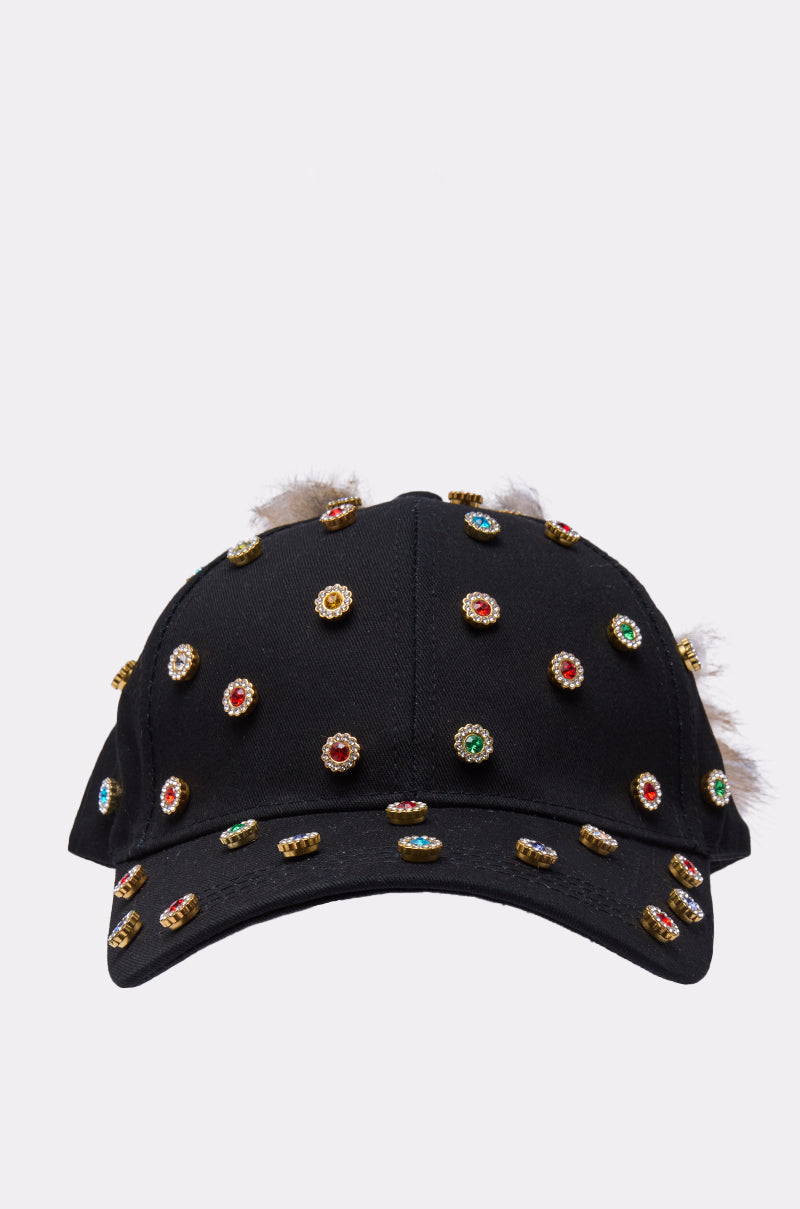 The TJ FAUX FUR EMBELLISHED HAT by AKIRA Label is a black baseball cap featuring faux fur and multiple gold-rimmed, colorful gemstone-like studs evenly spaced across the front and brim. 4