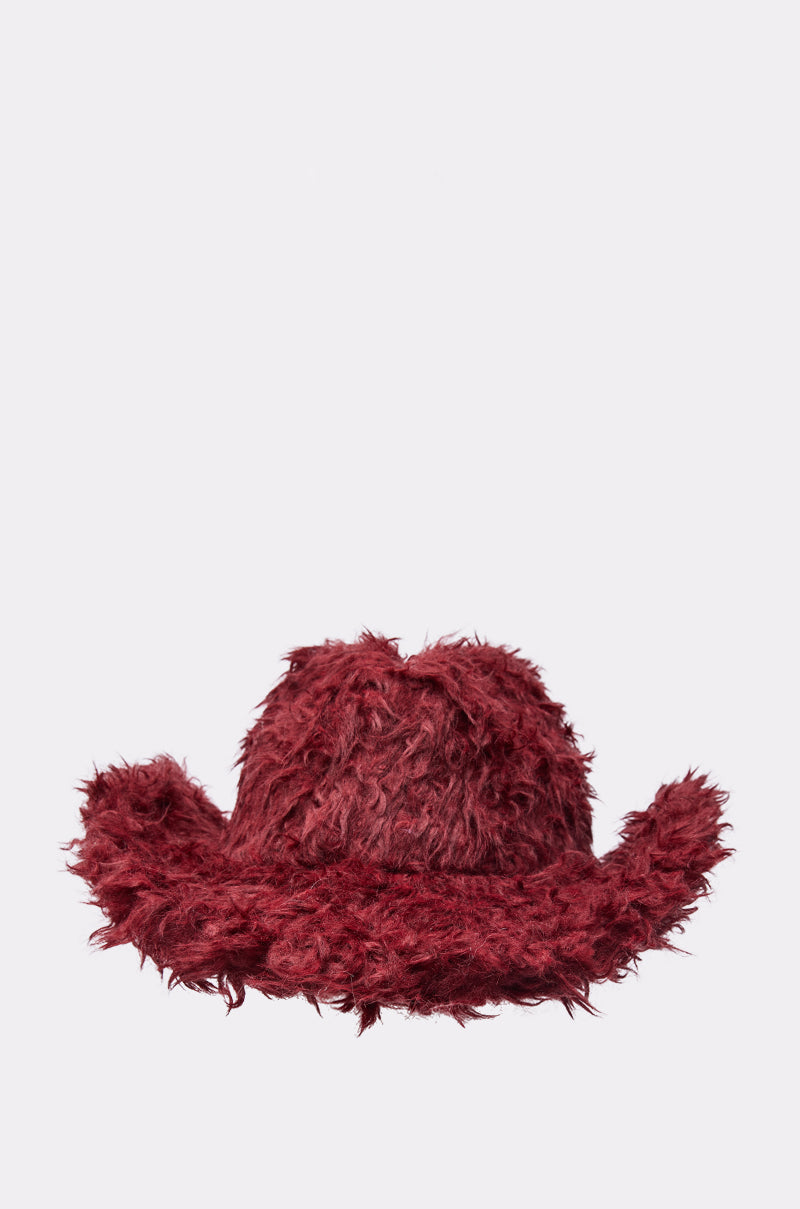 The FOR THE VIBES FAUX FUR COWBOY HAT features a shaggy, deep red, wide-brimmed design and is shown against a plain light gray background—ideal for making a bold festival statement. 3