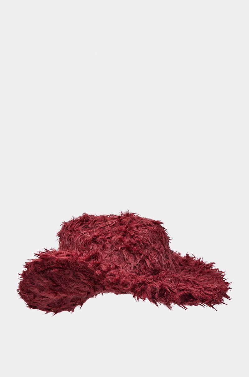 The FOR THE VIBES FAUX FUR COWBOY HAT features a wide, floppy brim and textured, shaggy deep burgundy faux fur—an eye-catching festival accessory—shown against a plain light gray background. 4