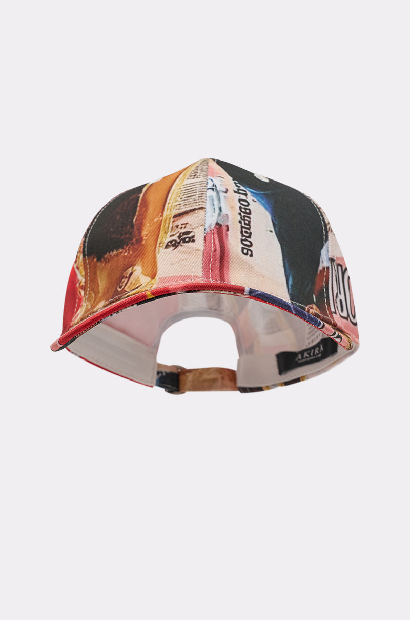 The IN THE ZINE PRINT HAT is a bold, street-style cap with a colorful graphic design, abstract patterns, vibrant text, and an adjustable strap—perfect for standout looks. 3