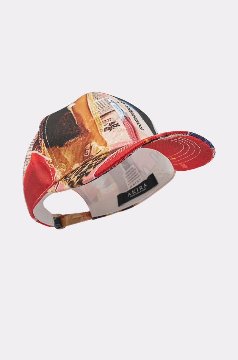Add street-style flair with the IN THE ZINE PRINT HAT—a colorful baseball cap featuring a magazine print collage, adjustable back strap, and an inner black label with white "AKIRA" text. 4