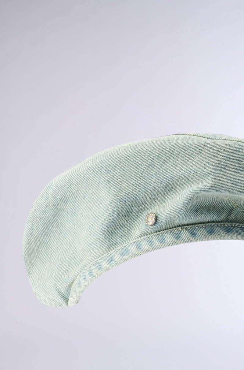 The light green IN MY POCKET DENIM BERET by TOROS ACCESSORIES, perfect as an autumn accessory, features a small round logo embroidered near the brim. It is displayed against a plain, light gray background.