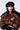 A person sporting a black STAY CONNECTED GROMMET BERET and a shiny brown puffer jacket with wide shoulders, perfect for fall fashion, is looking at the camera. The jacket has black accents, complementing the person's long, dark hair and fair skin.