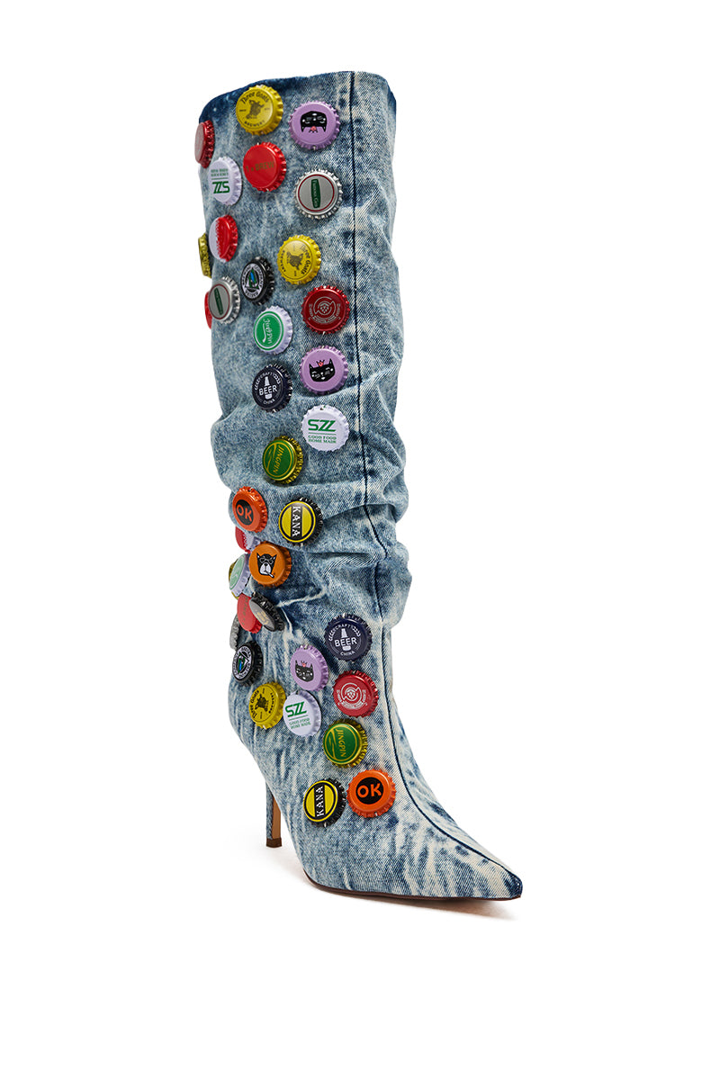 The AZALEA WANG THELEN Denim Bottle Cap Stiletto Boot is a knee-high denim boot with chic button details, adding a stylish twist to your look.