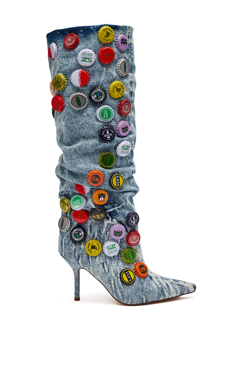 The AZALEA WANG THELEN DENIM BOTTLE CAP STILETTO BOOT is a knee-high denim boot featuring button details.