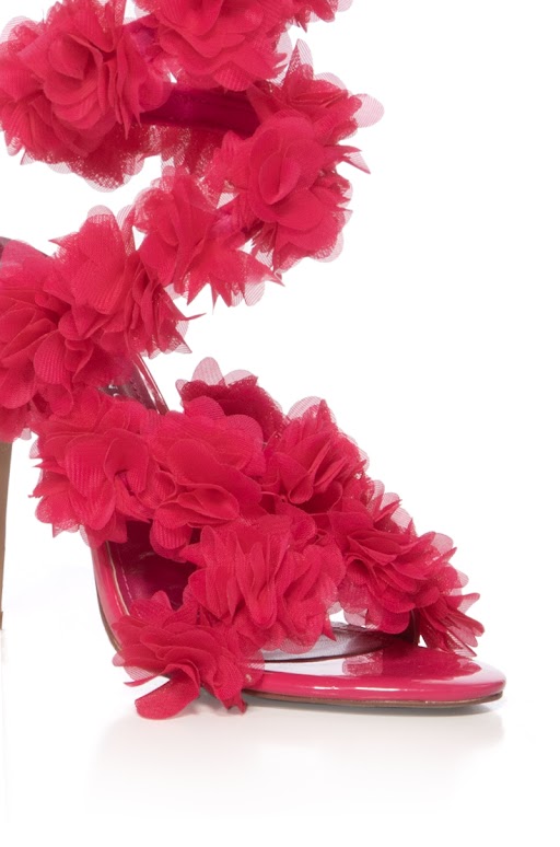 A close-up of the AZALEA WANG THEODOSIA PINK STILETTO SANDAL, showcasing vibrant pink floral appliques, an open toe, and ankle strap, set against a white background.